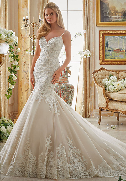 Fit and flare wedding dress with sweetheart neckline and spaghetti straps.