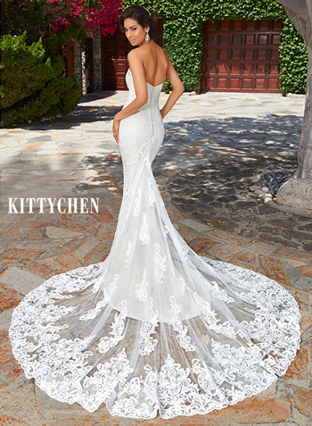 Wedding dress with sheer bodice is offset by dramatic embroidery and paired with a satin skirt. 